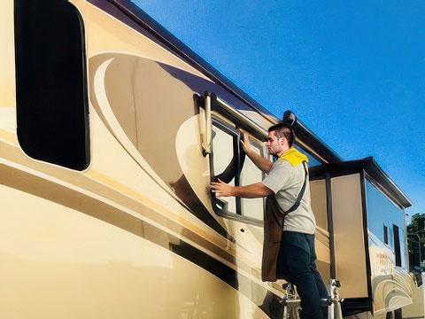 Technician inspecting an RV windshield at New View Auto Glass